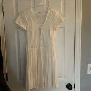 Hollister white short sleeve dress with floral sleeves and zigzag in the front